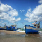 Boats on a beach when the tide is out