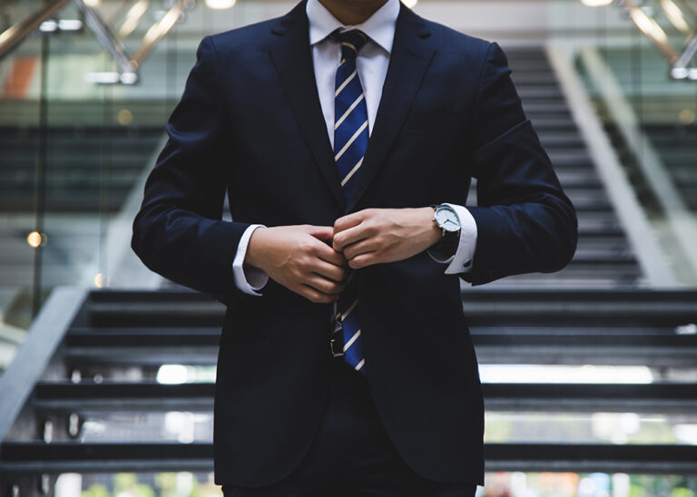 Man adjusting his tie